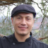 photo of Rosario Baucino, man with black chef jacket and cap